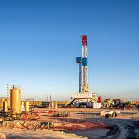 A lone drilling Fracking Rig on a prairie.
