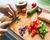 Woman preparing vegetables and salmon on chopping board