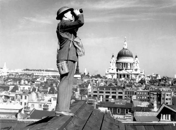 Aircraft spotter on the roof of a building in London with St. Paul's Cathedral in the background, ca. 1940 exact date unknown. Battle of Britain, The Blitz, World War II, Great Britain