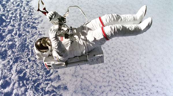 Above the clouds 130 nautical miles below, astronaut Mark C. Lee floats freely without tethers as he tests the new Simplified Aid for Extravehicular Activity (EVA) Spacewalk Rescue (SAFER) system, Sept. 16, 1994. Space Shuttle Discovery, STS-64